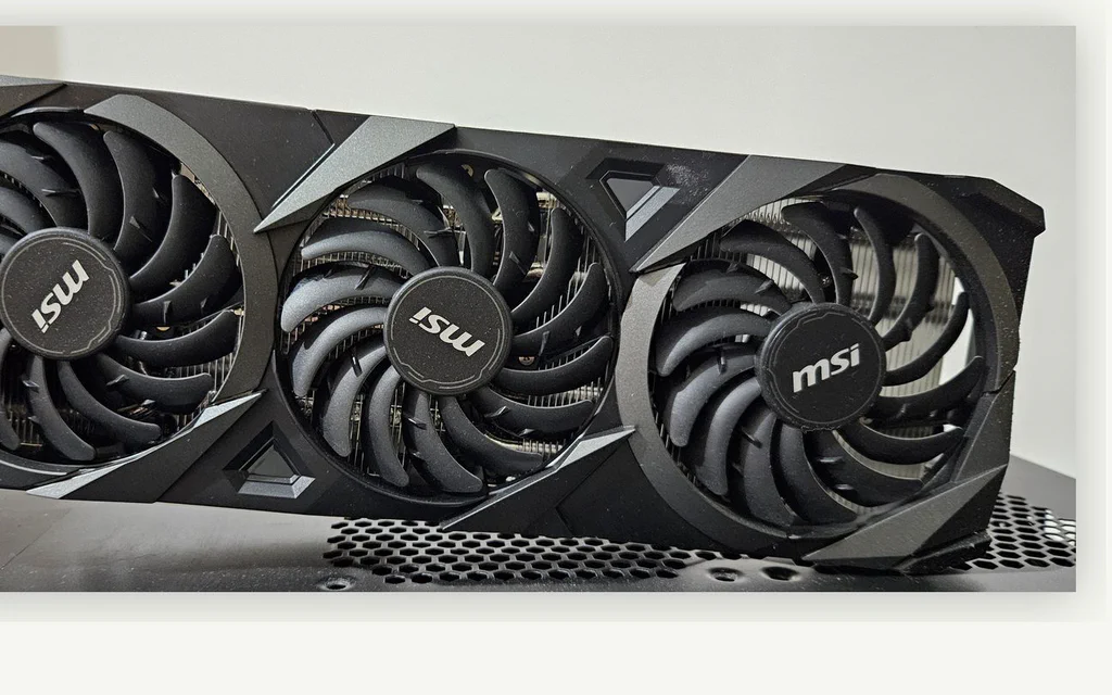 Triple-fan graphics card used as a representative photo for a 1080p GPU buying guide.