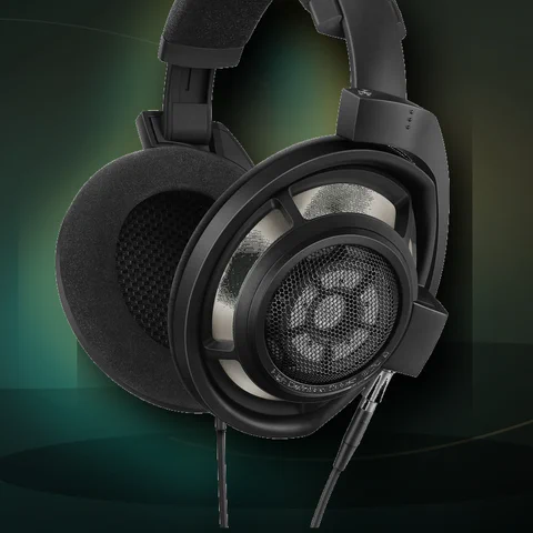Premium open-back headphones on a dark studio-style background.