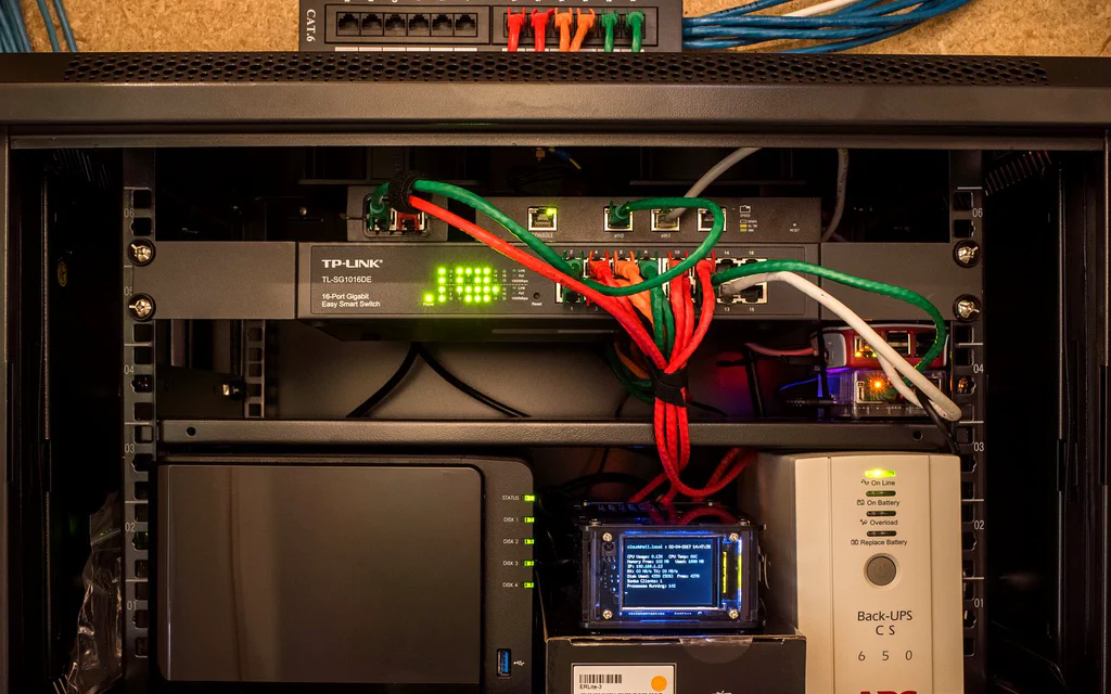 Home network cabinet with a switch, NAS, small router and UPS battery backup.